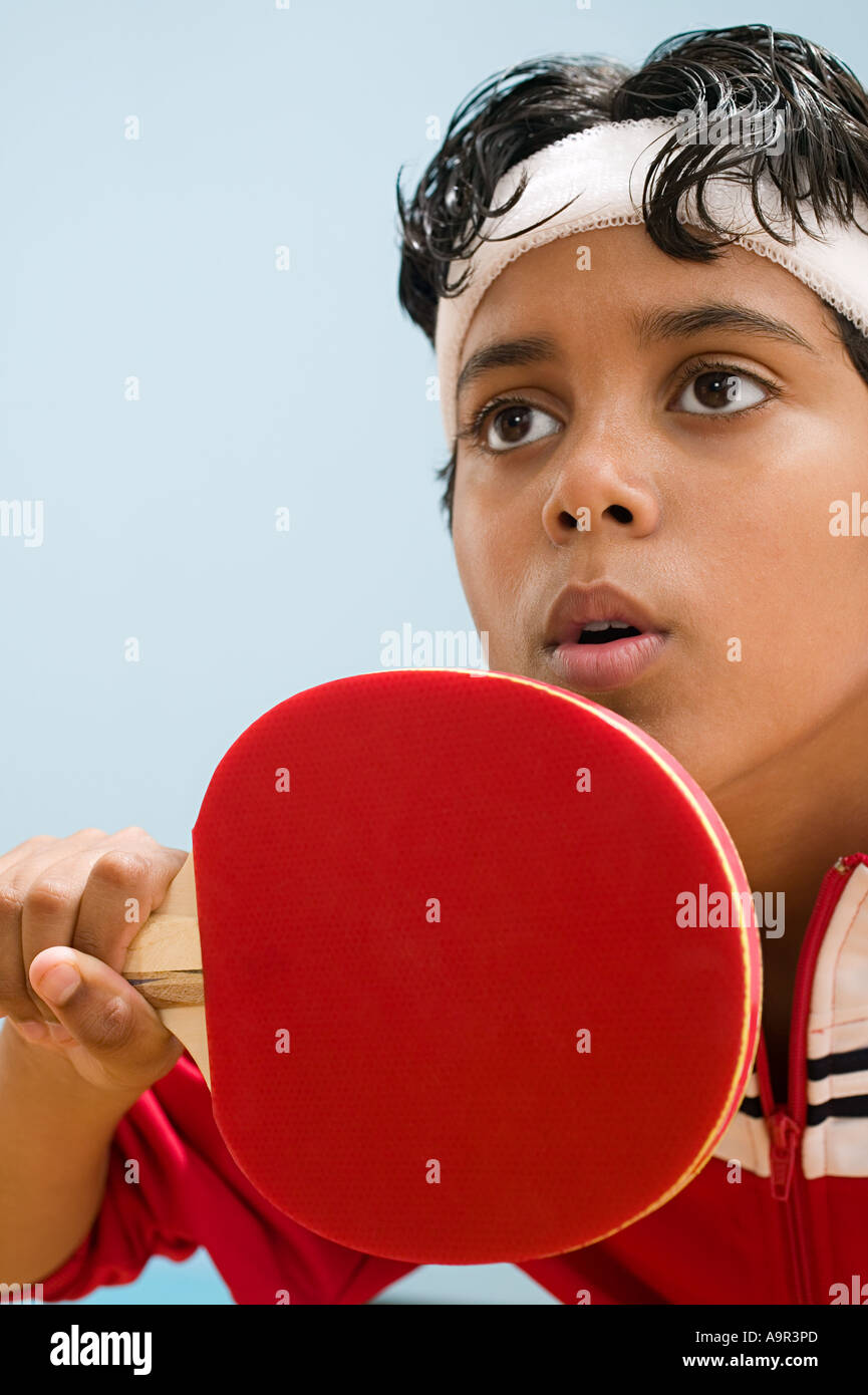 Boy holding table tennis paddle Stock Photo Alamy