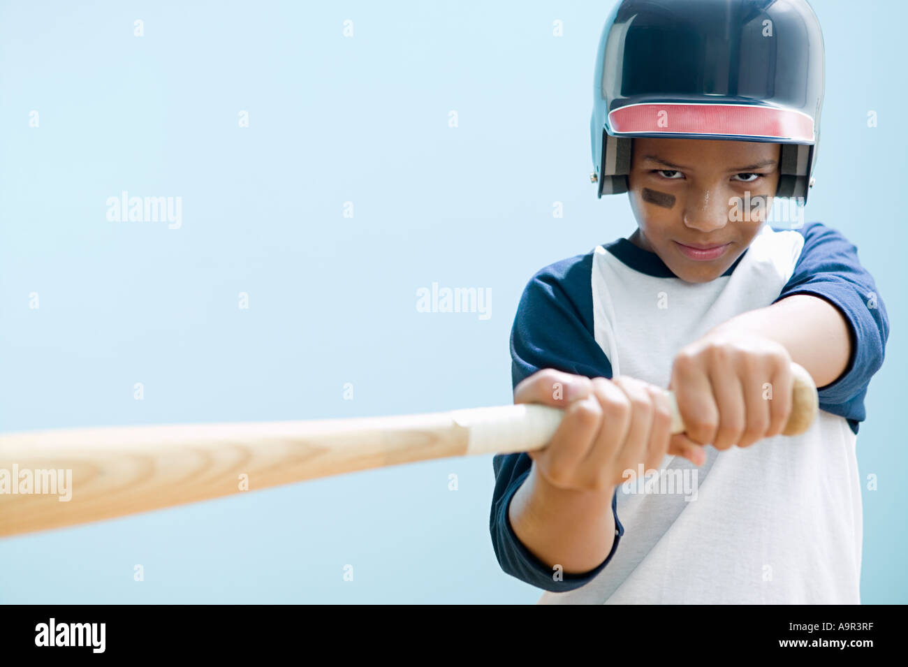 Boy swinging baseball bat Stock Photo Alamy