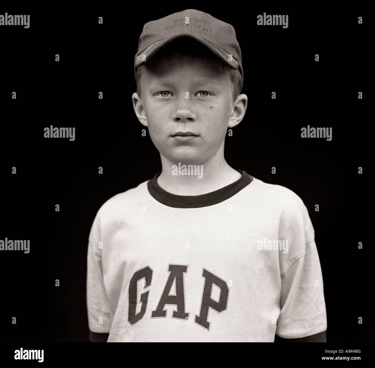 Boy wearing GAP T-shirt boy, baseball cap, school, bully, friends, games, play, playing, fashion, kids, young man, youth, black Stock Photo