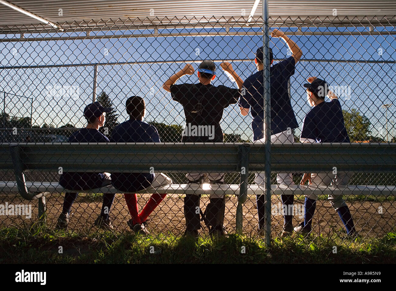 Five teenagers watching from the sidelines Stock Photo - Alamy