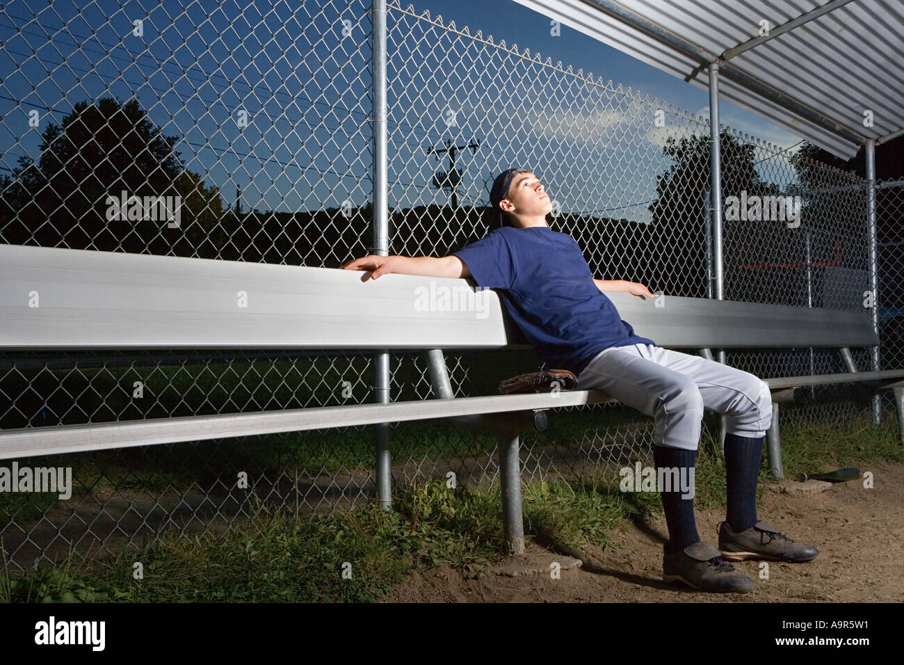 Teenage boy watching from the sidelines Stock Photo Alamy