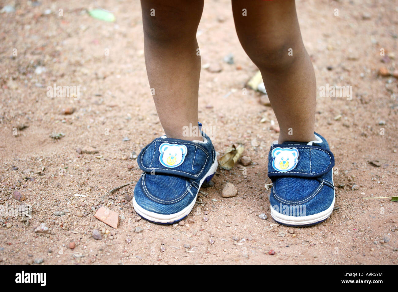 Feet of a baby with shoes Stock Photo - Alamy