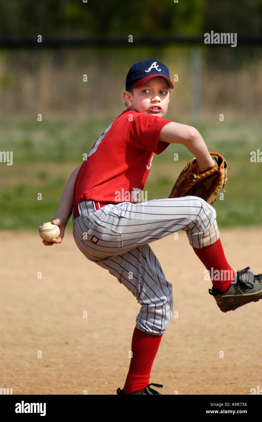MRed Little league baseball game with full safety gear all boys ages