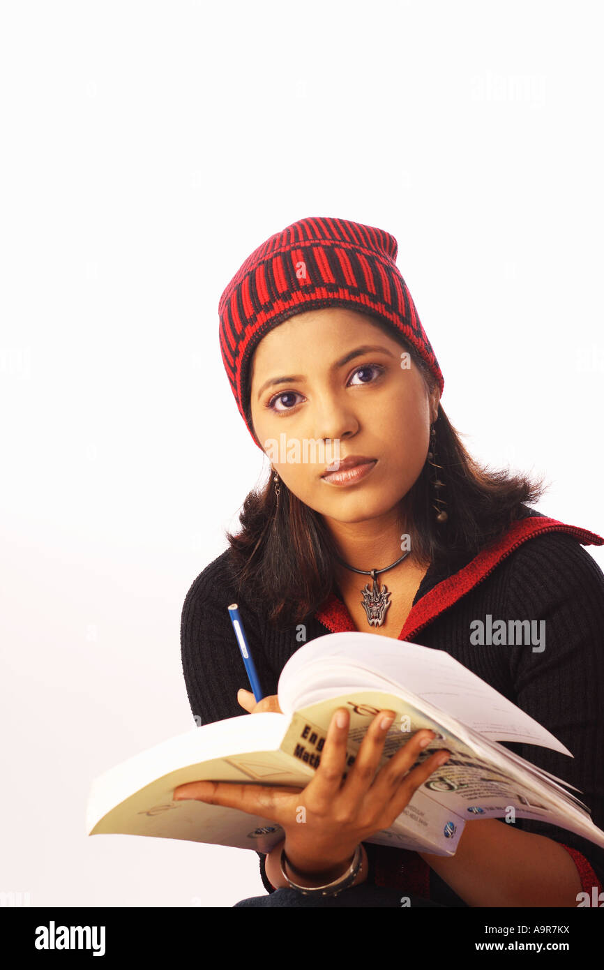 Portrait of a young woman holding a book and a pencil Stock Photo - Alamy