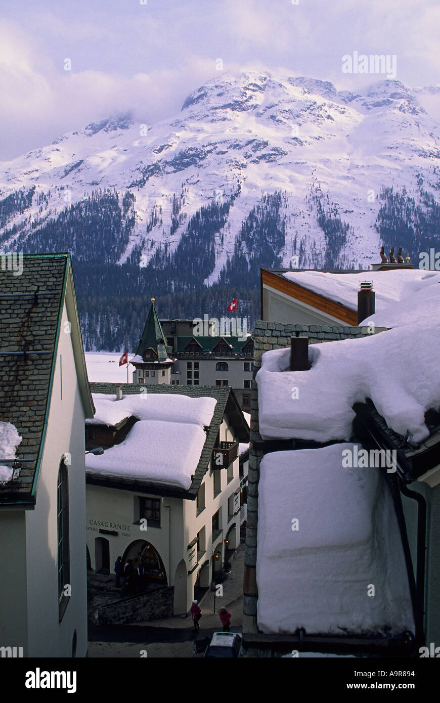 Switzerland St Moritz view toward Palace Hotel with flags winter snow Stock Photo