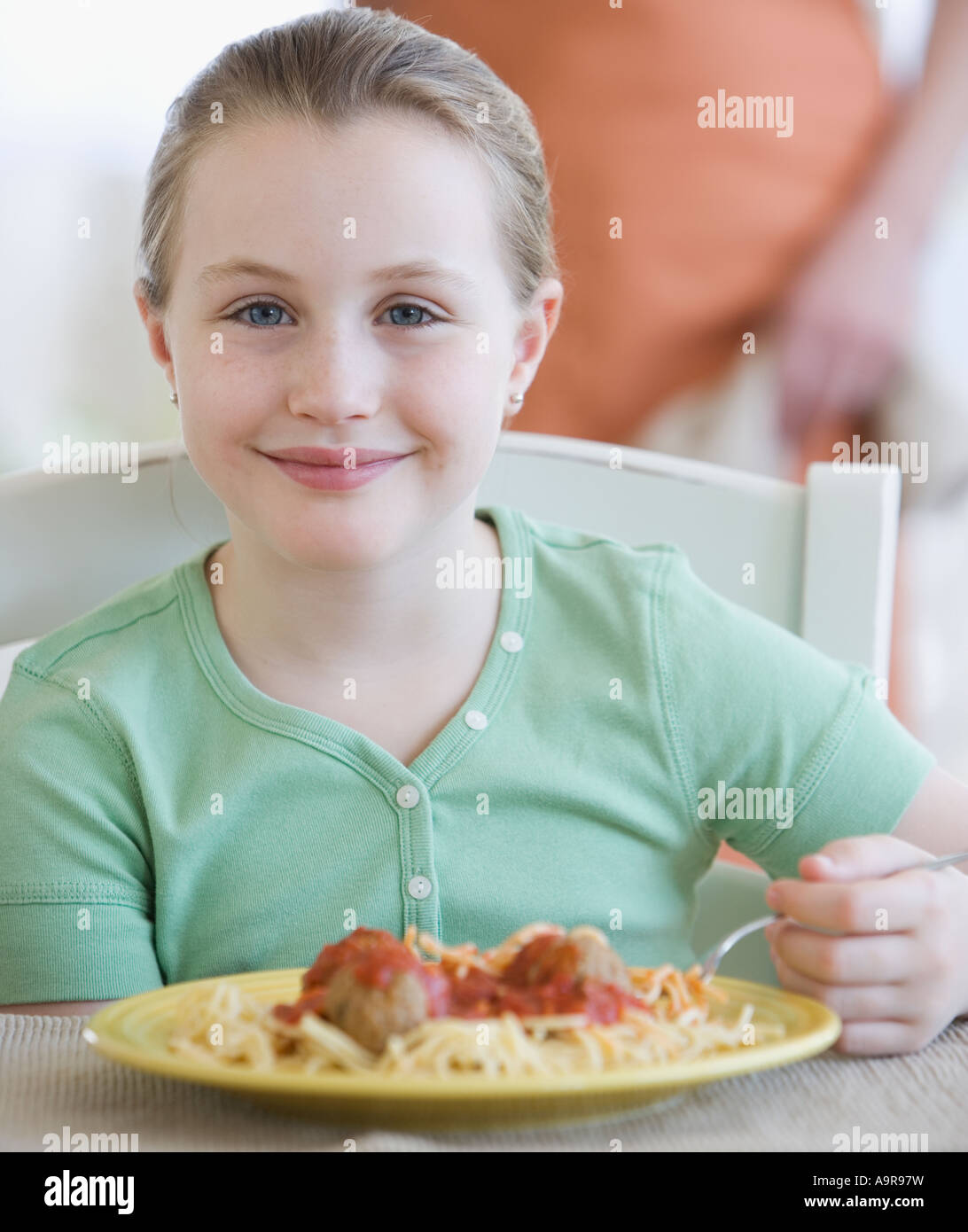 Girl eating spaghetti and meatballs Stock Photo