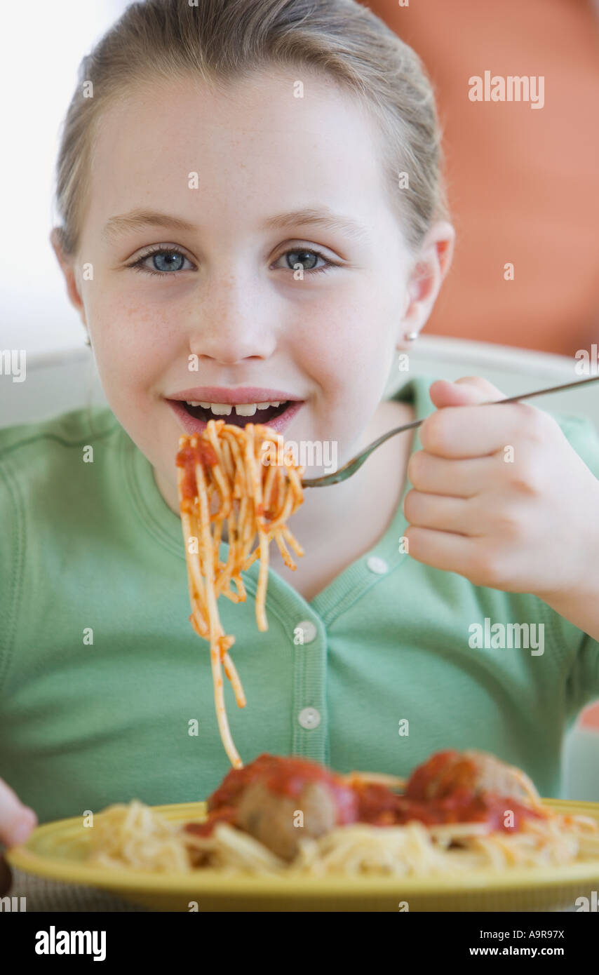 Girl eating spaghetti and meatballs Stock Photo Alamy