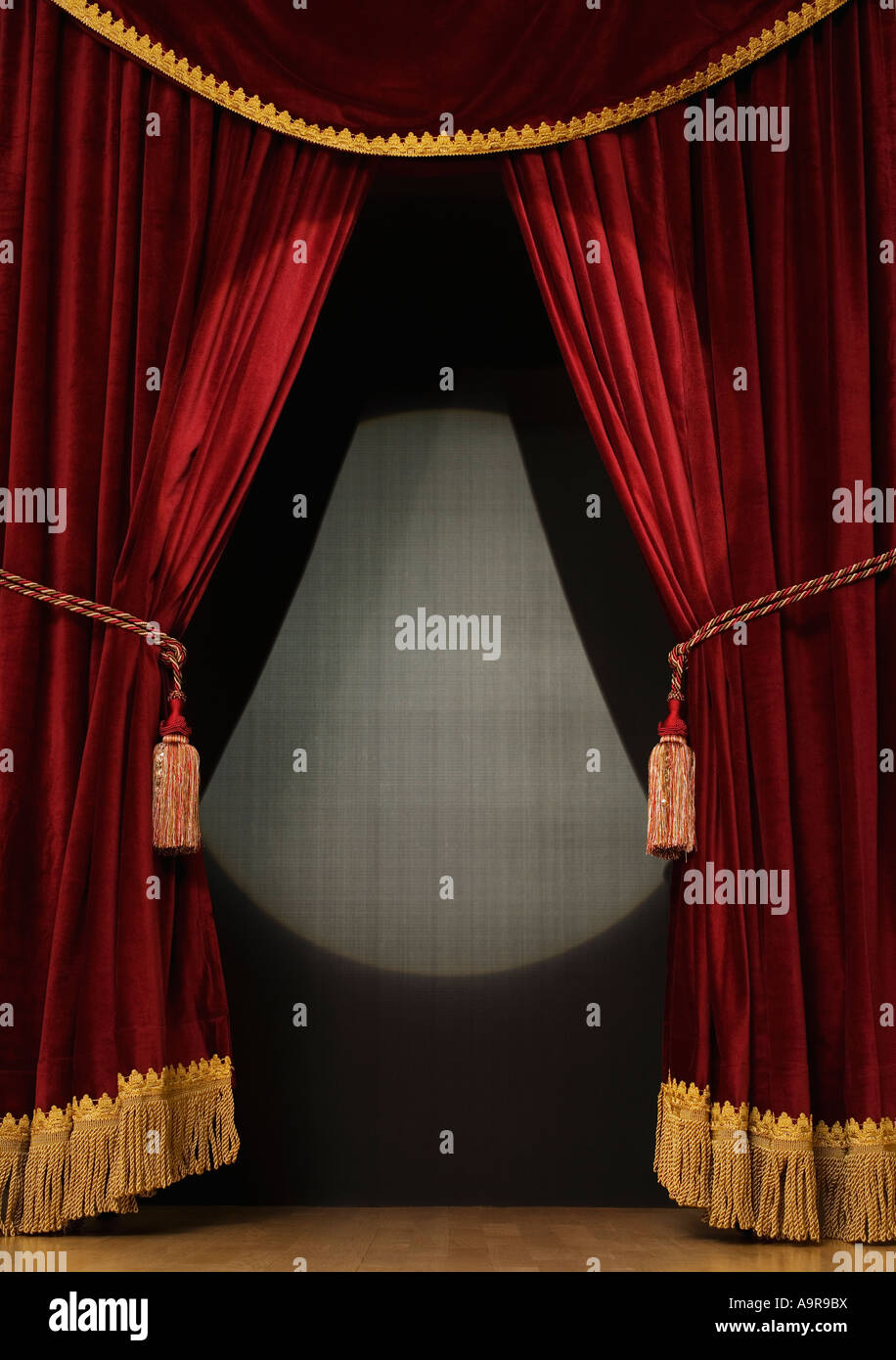 Spotlight on open stage curtains Stock Photo - Alamy