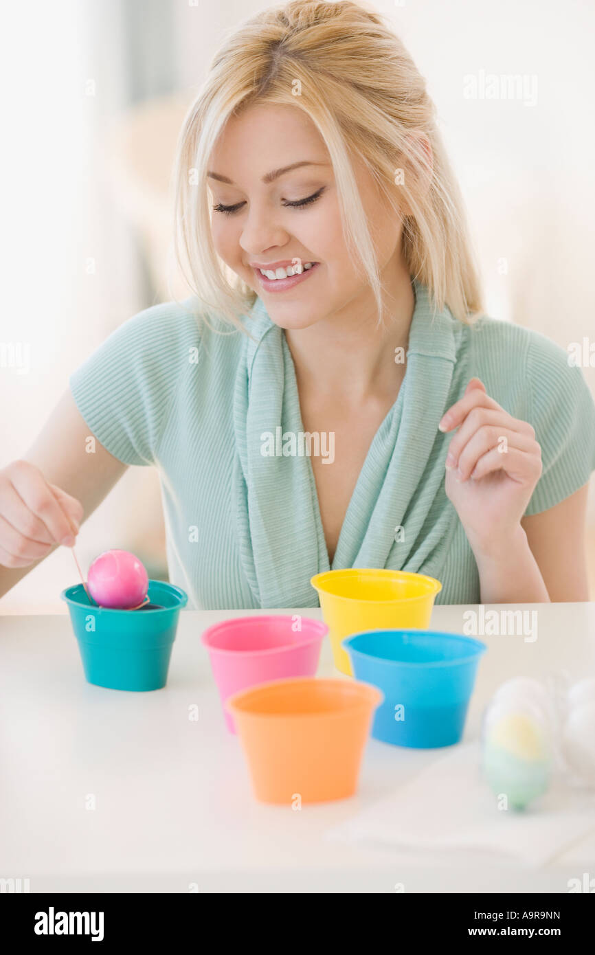 Woman dying Easter eggs Stock Photo