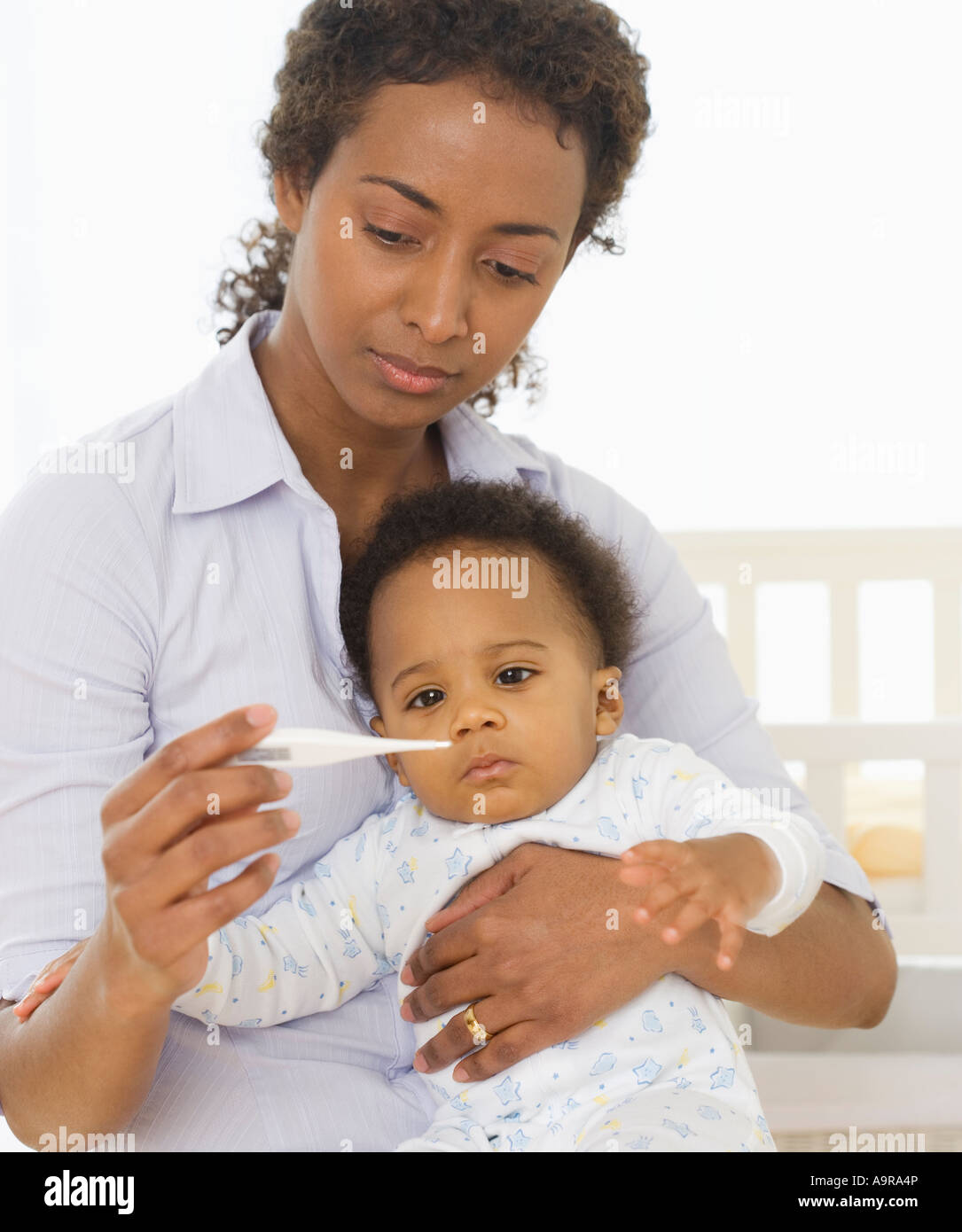 Mother taking baby s temperature Stock Photo Alamy