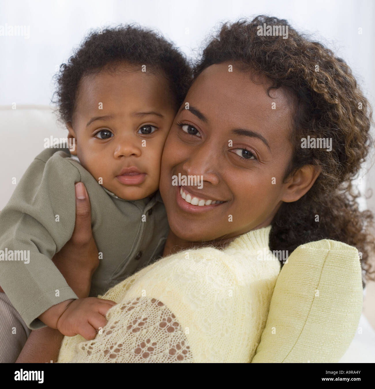 Portrait of mother and baby hugging Stock Photo - Alamy