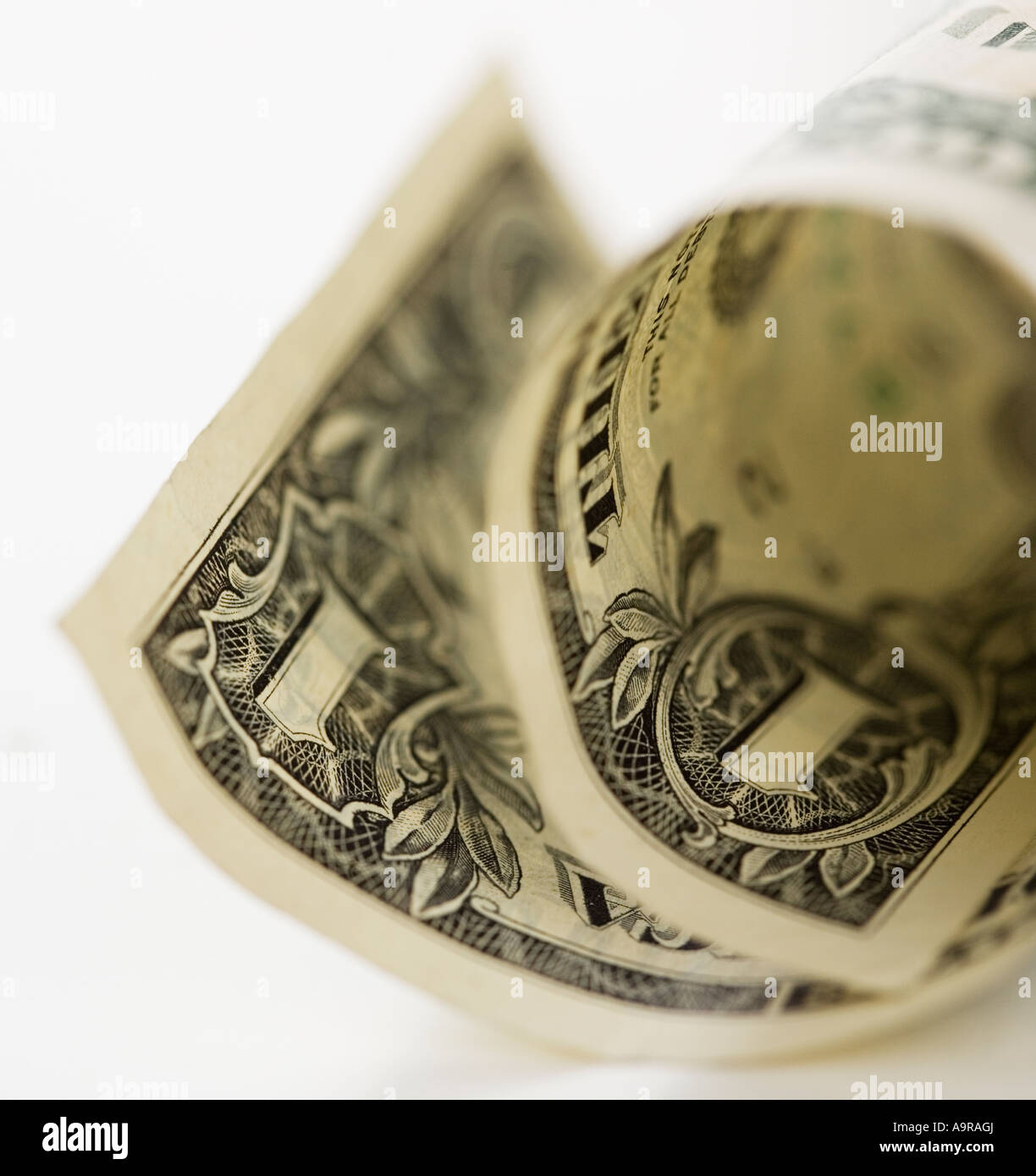 Close up of curled dollar bill Stock Photo - Alamy