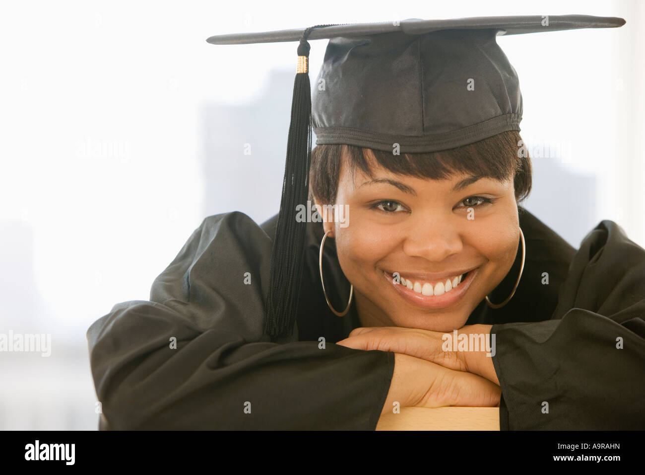 African woman wearing graduation cap and gown Stock Photo
