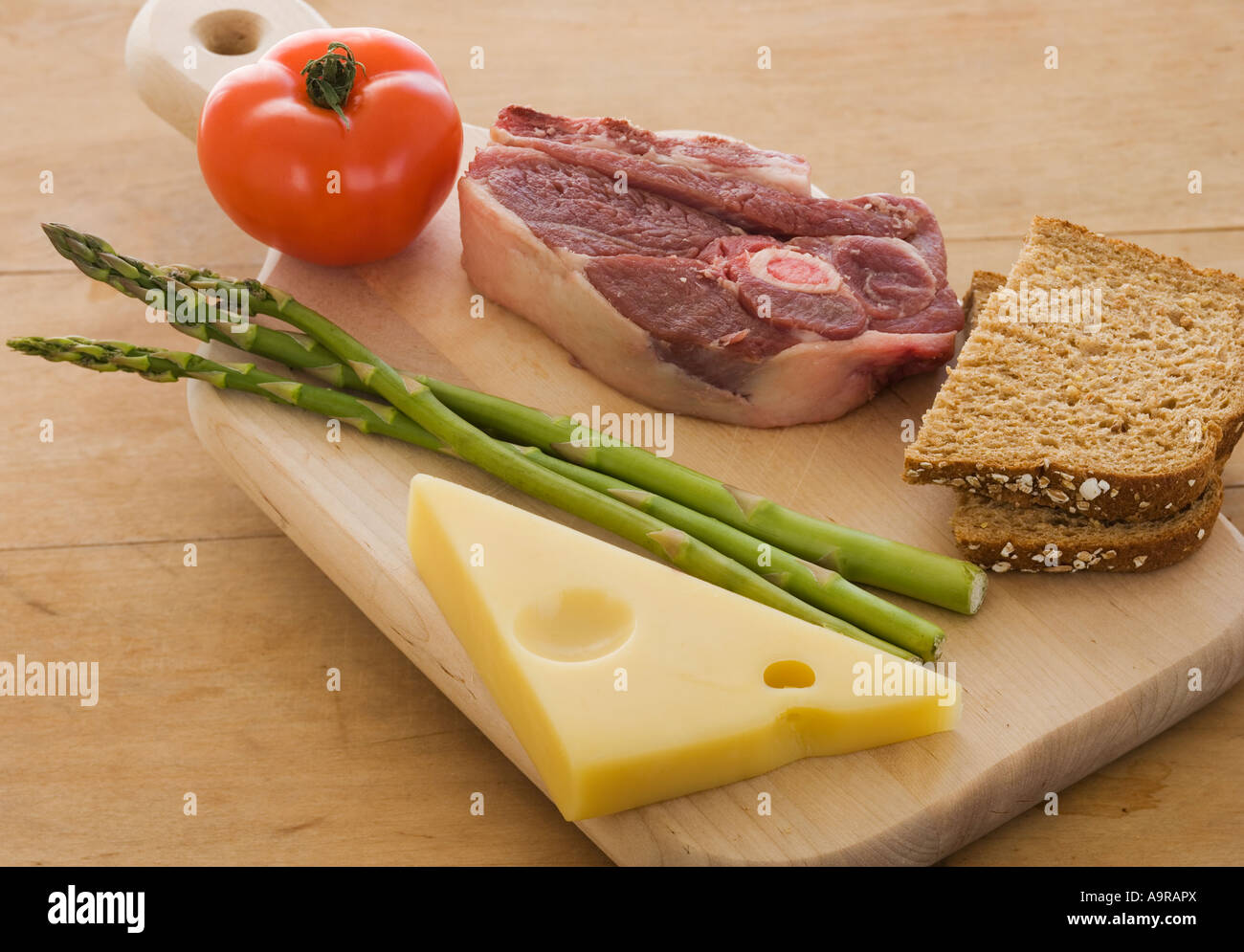 Assorted food groups on cutting board Stock Photo Alamy