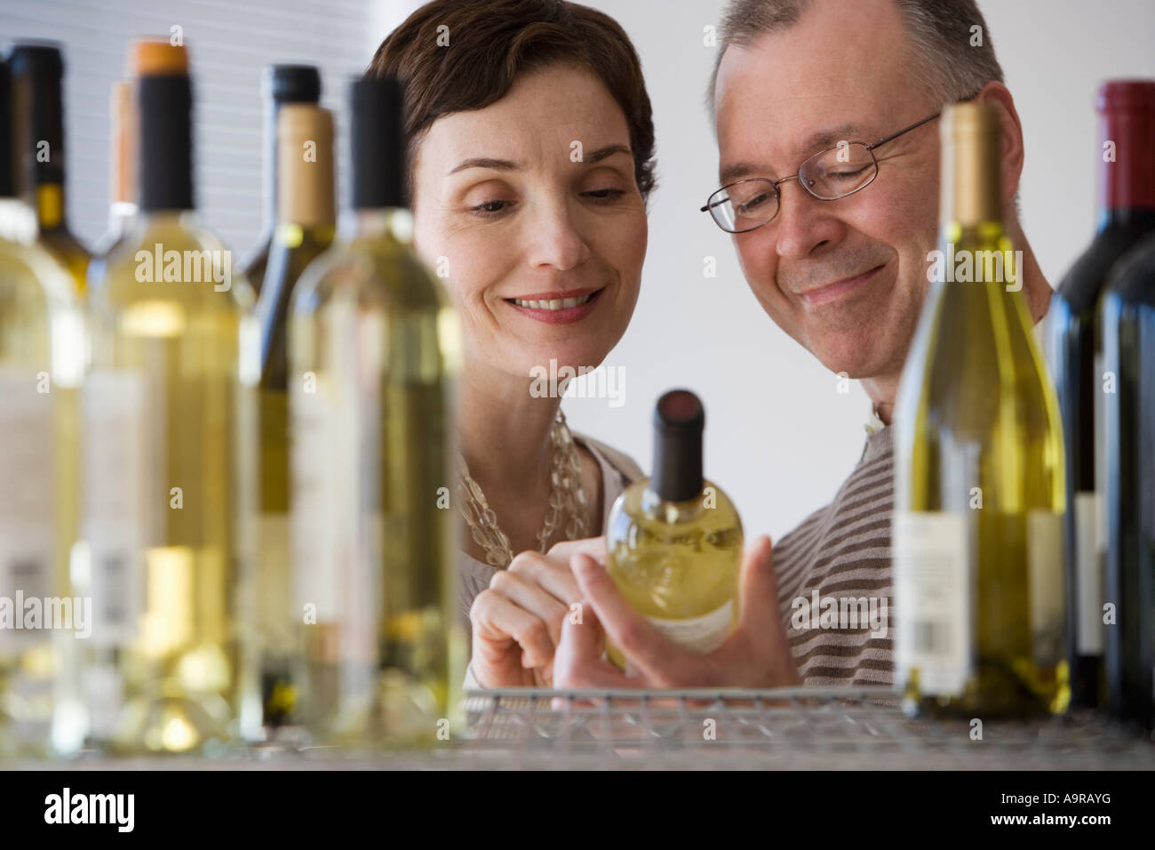 Couple looking at wine in store Stock Photo Alamy