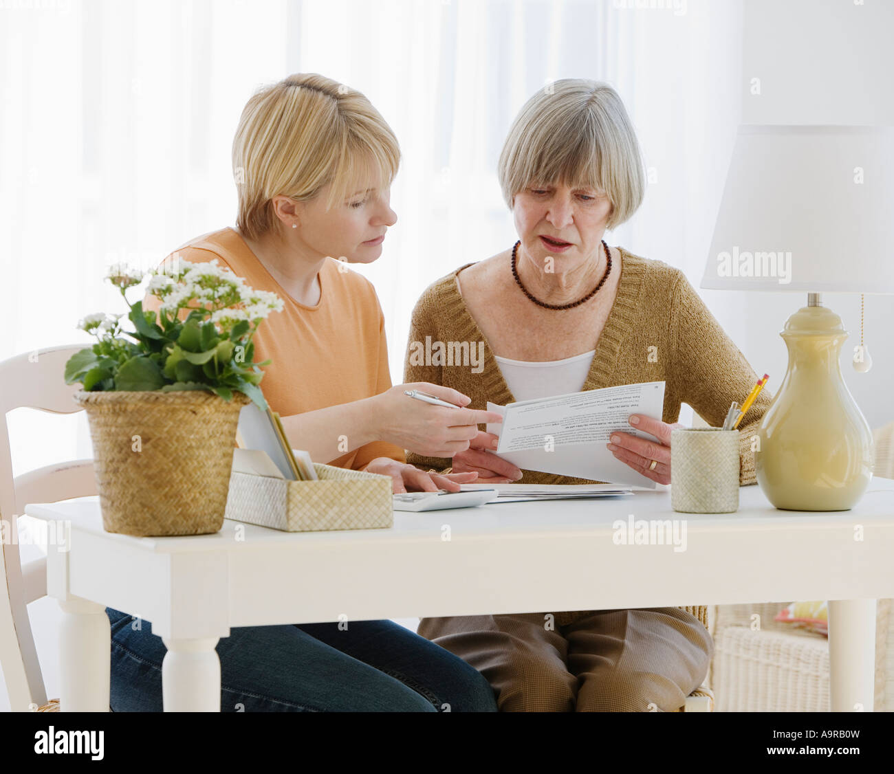 Adult daughter assisting senior mother hi-res stock photography and ...
