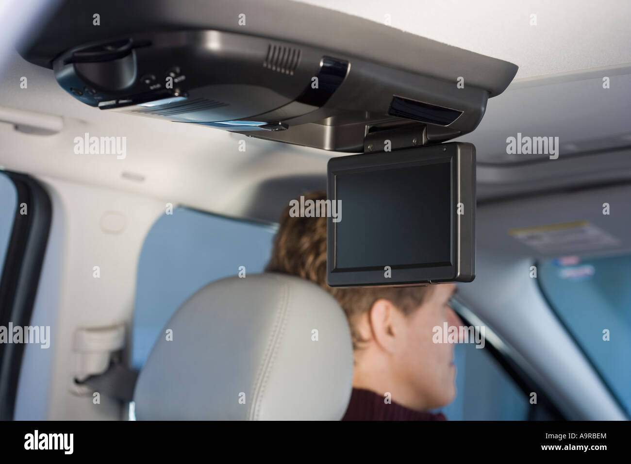 Television screen in car with man driving Stock Photo Alamy