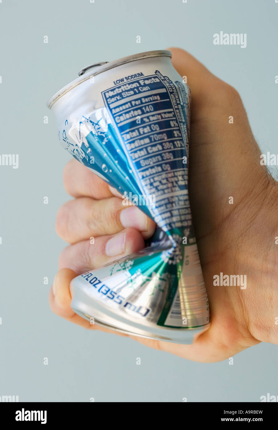 Man crushing tin can Stock Photo Alamy