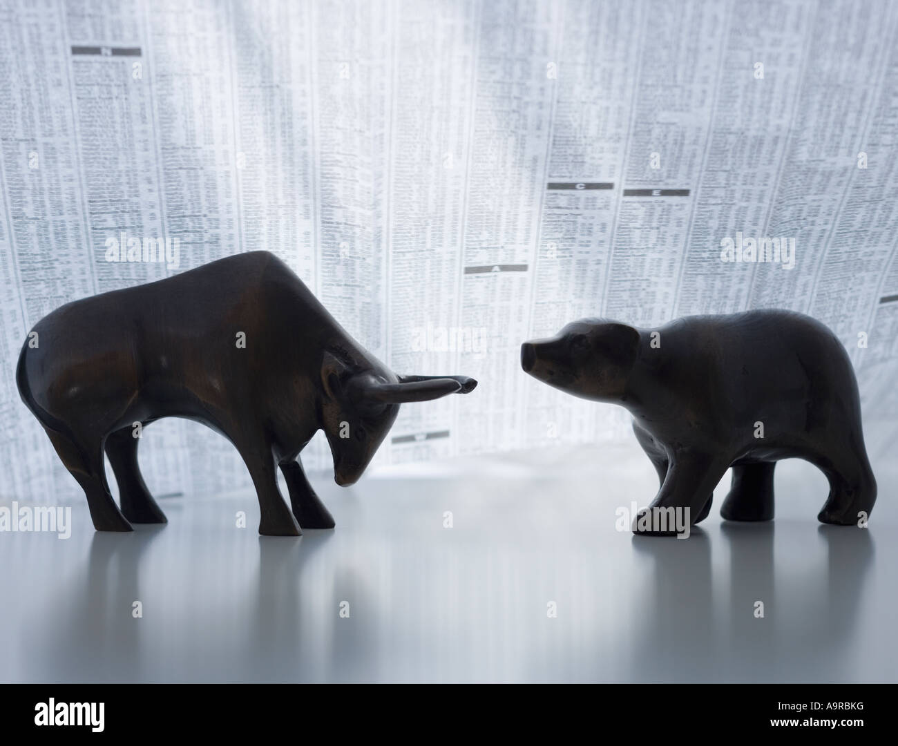 Bear and bull figurines facing each other Stock Photo