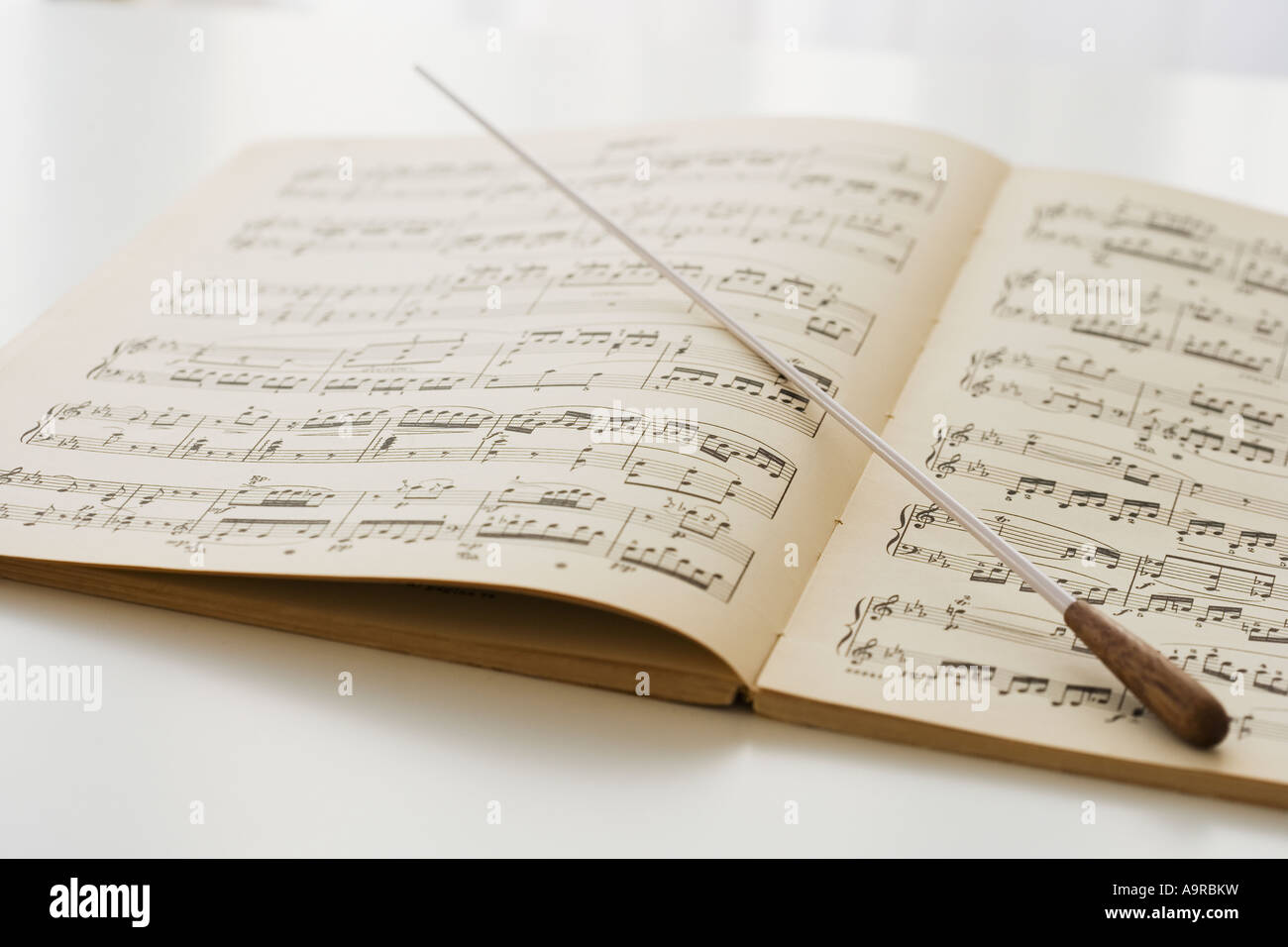Conductor s baton on sheet music Stock Photo Alamy