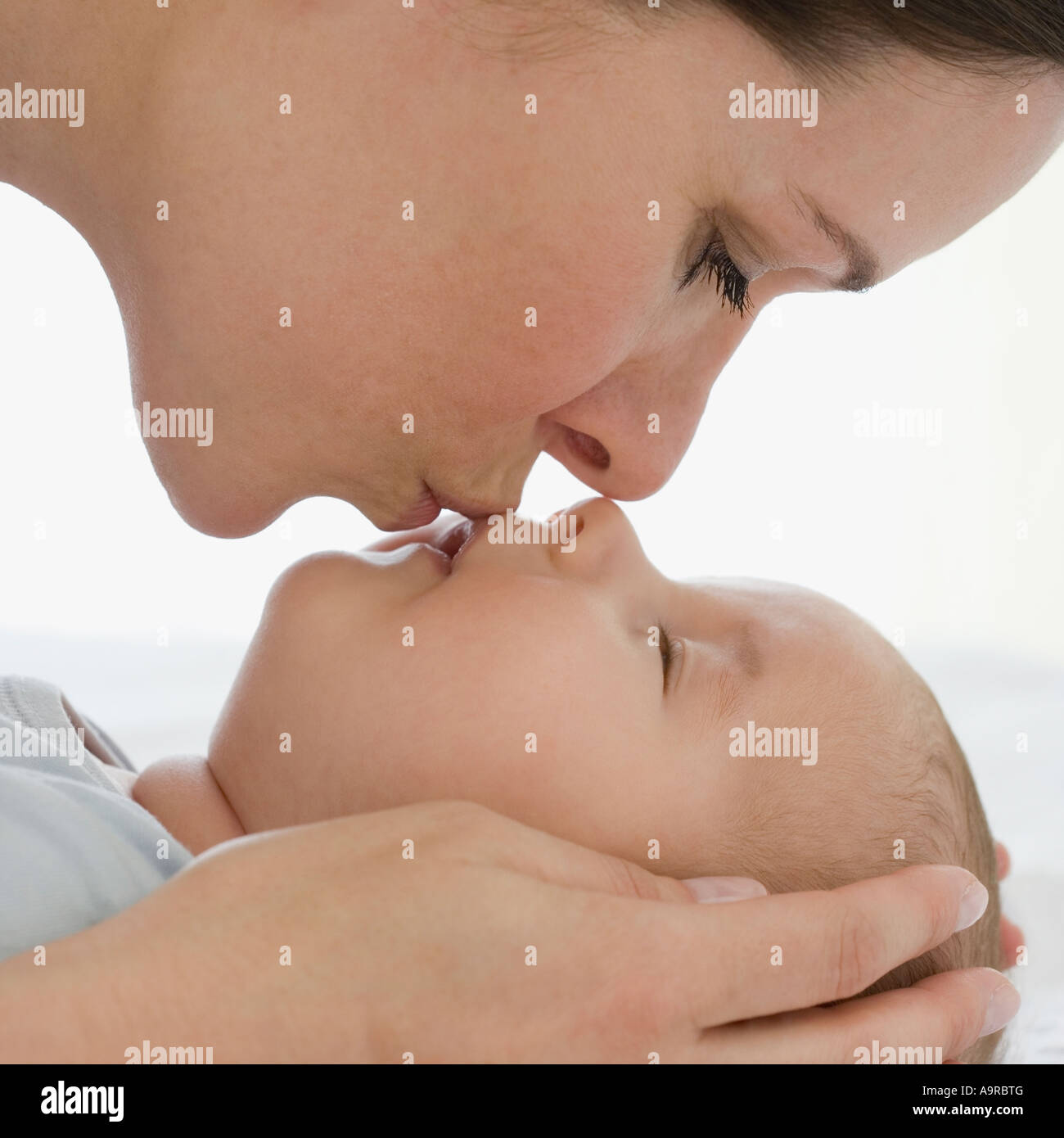Mother kissing bay Stock Photo
