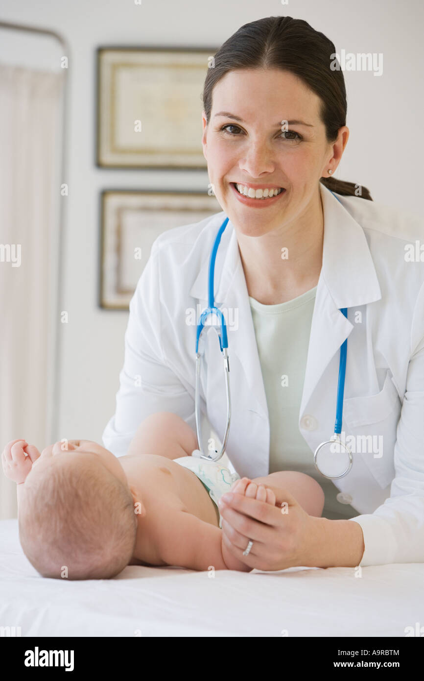 Female doctor examining baby Stock Photo - Alamy