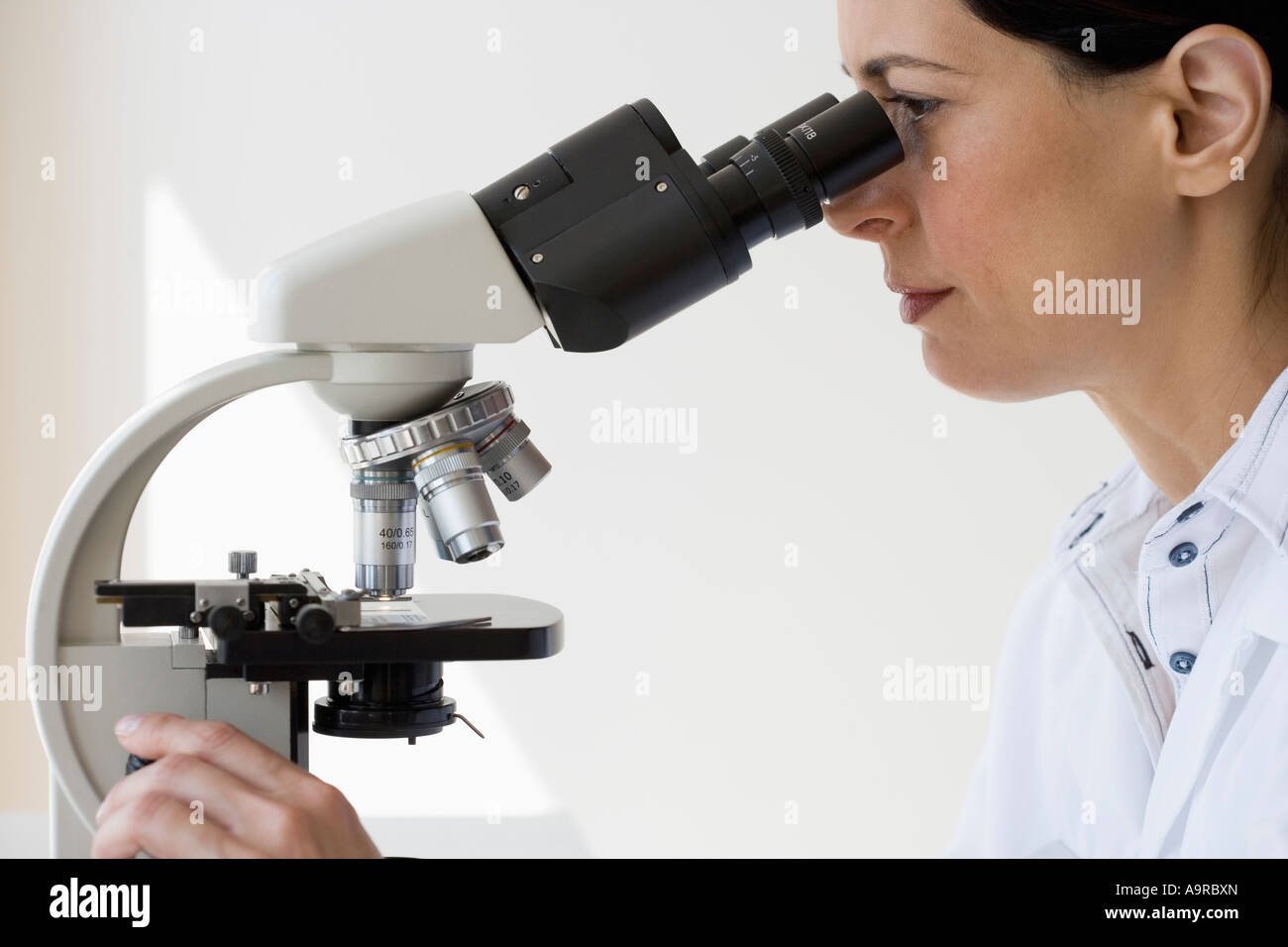 Female scientist looking into microscope Stock Photo Alamy