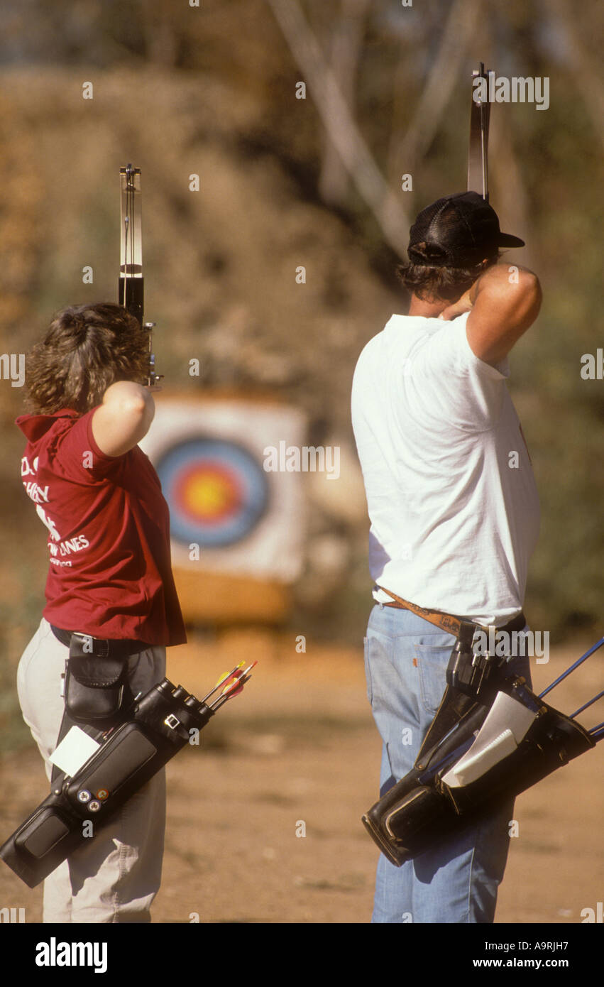 Two archers aiming for target. Stock Photo