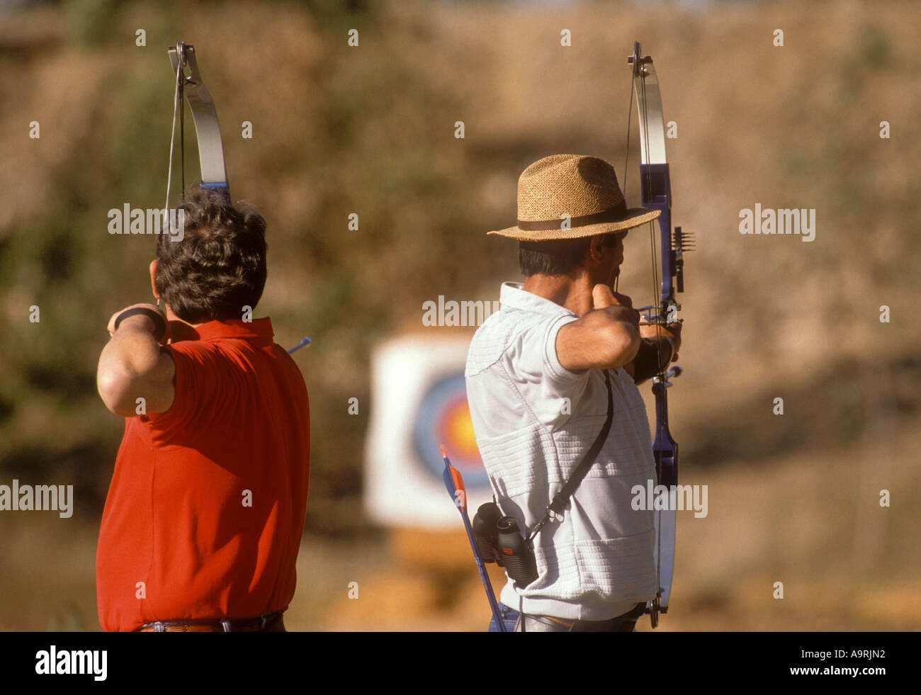 Two male archers aiming for target. Stock Photo