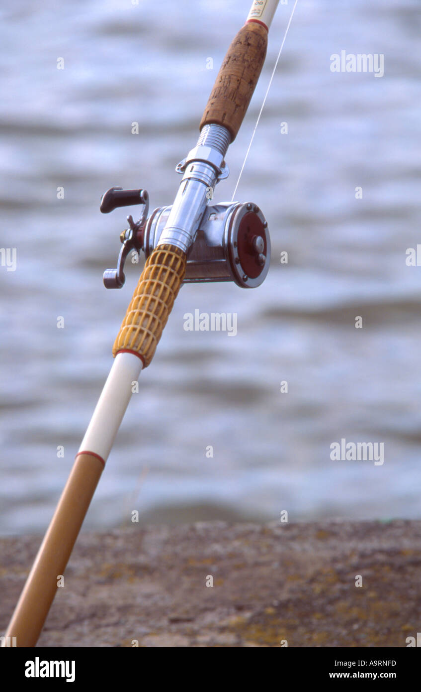 https://c8.alamy.com/comp/A9RNFD/a-strong-diagonal-composition-of-a-sea-fishing-rod-and-reel-with-waves-A9RNFD.jpg