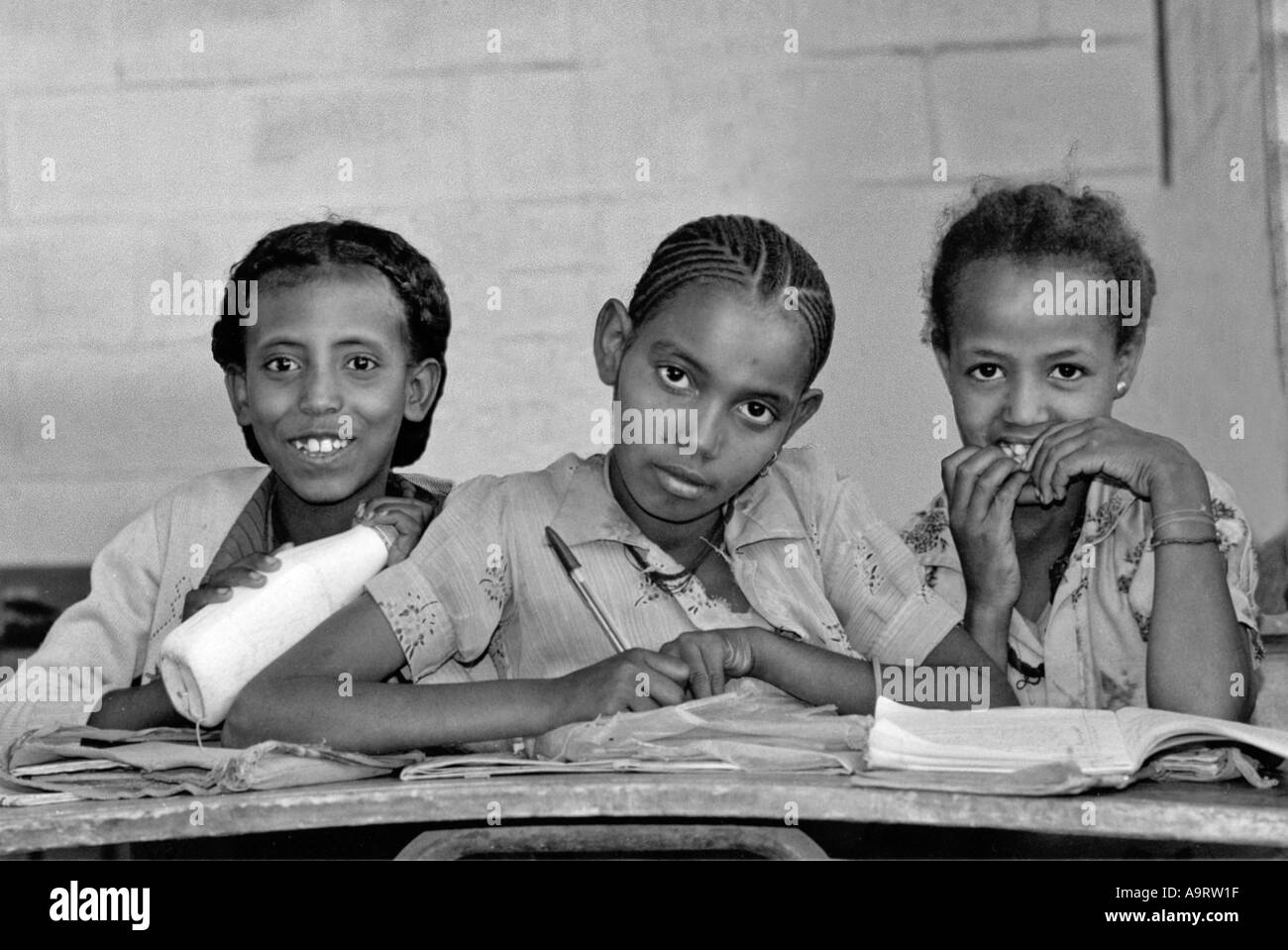 B/W of three schoolgirls seated at their desks in the classroom. Mekelle, Tigray, Ethiopia Stock Photo