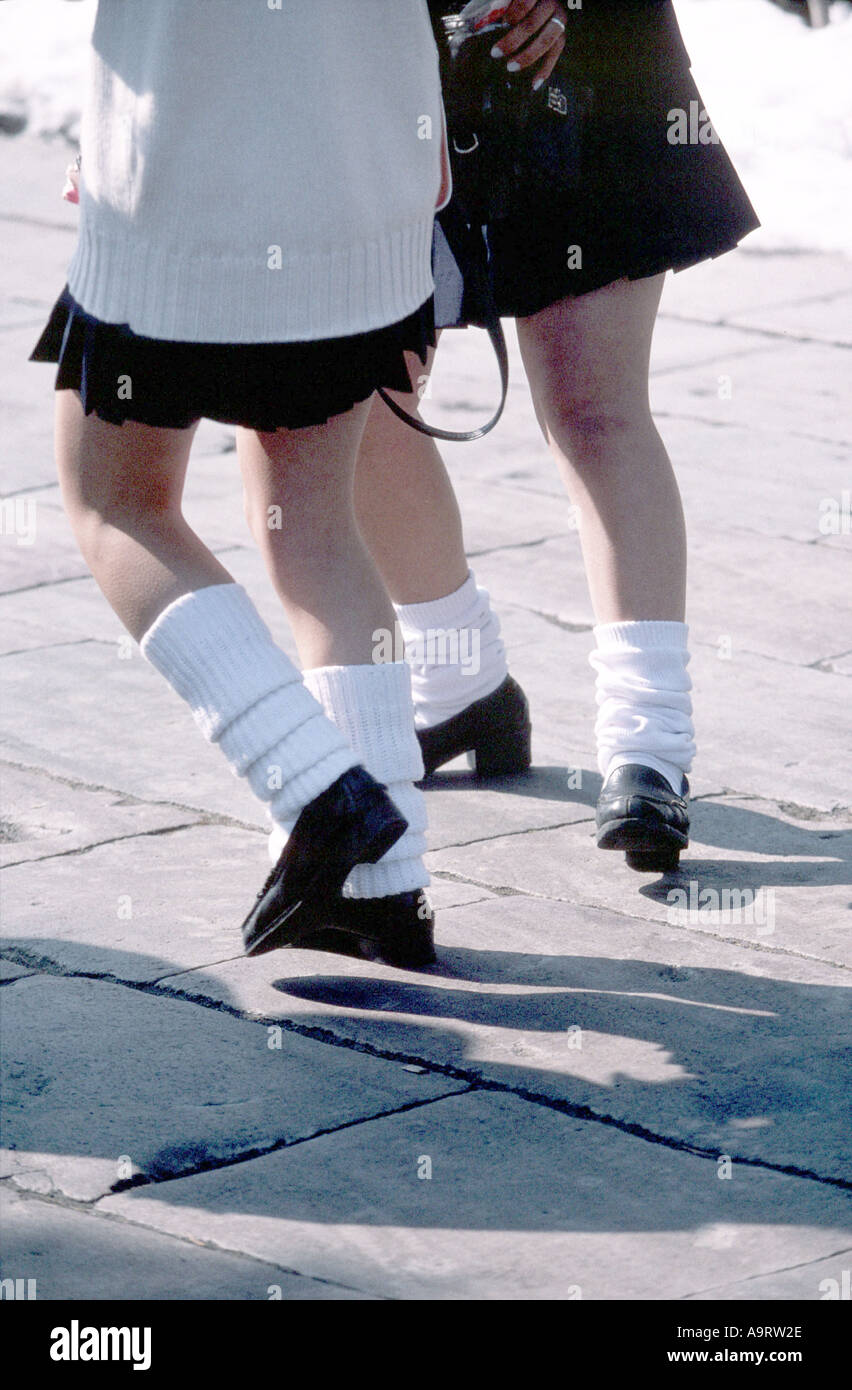 YOUNG GIRLS LEAVING SCHOOL PREMISES SOCKS HELD IN PLACE USING SOCK GLUE