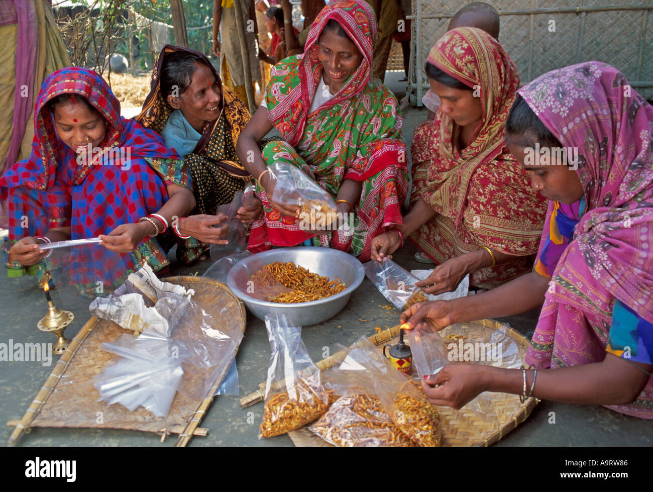 Women's cooperative making snacks on an income generation scheme. Bangladesh Stock Photo