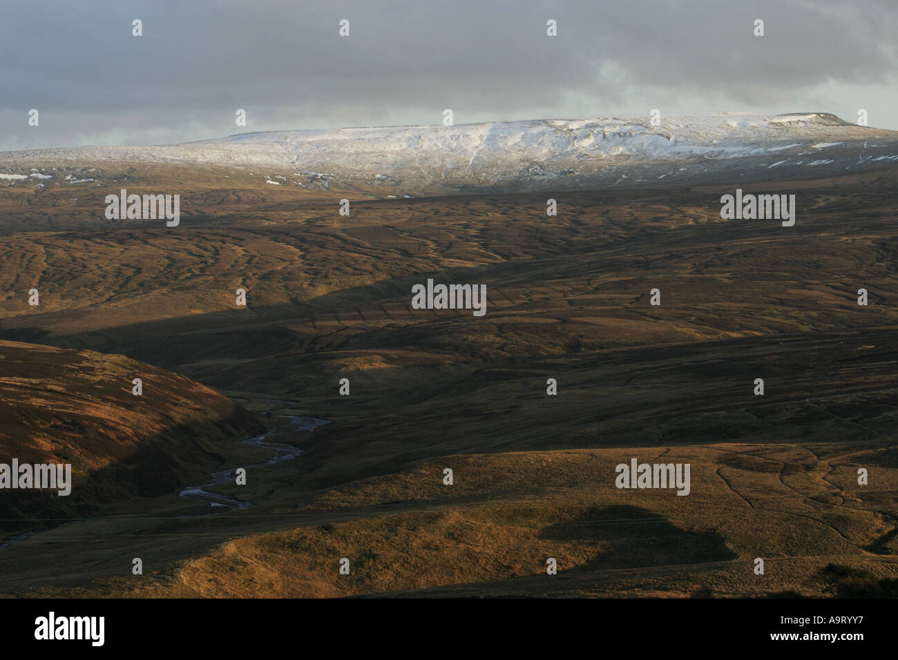 Cross Fell in winter from above Black Burn in the North Pennines Stock