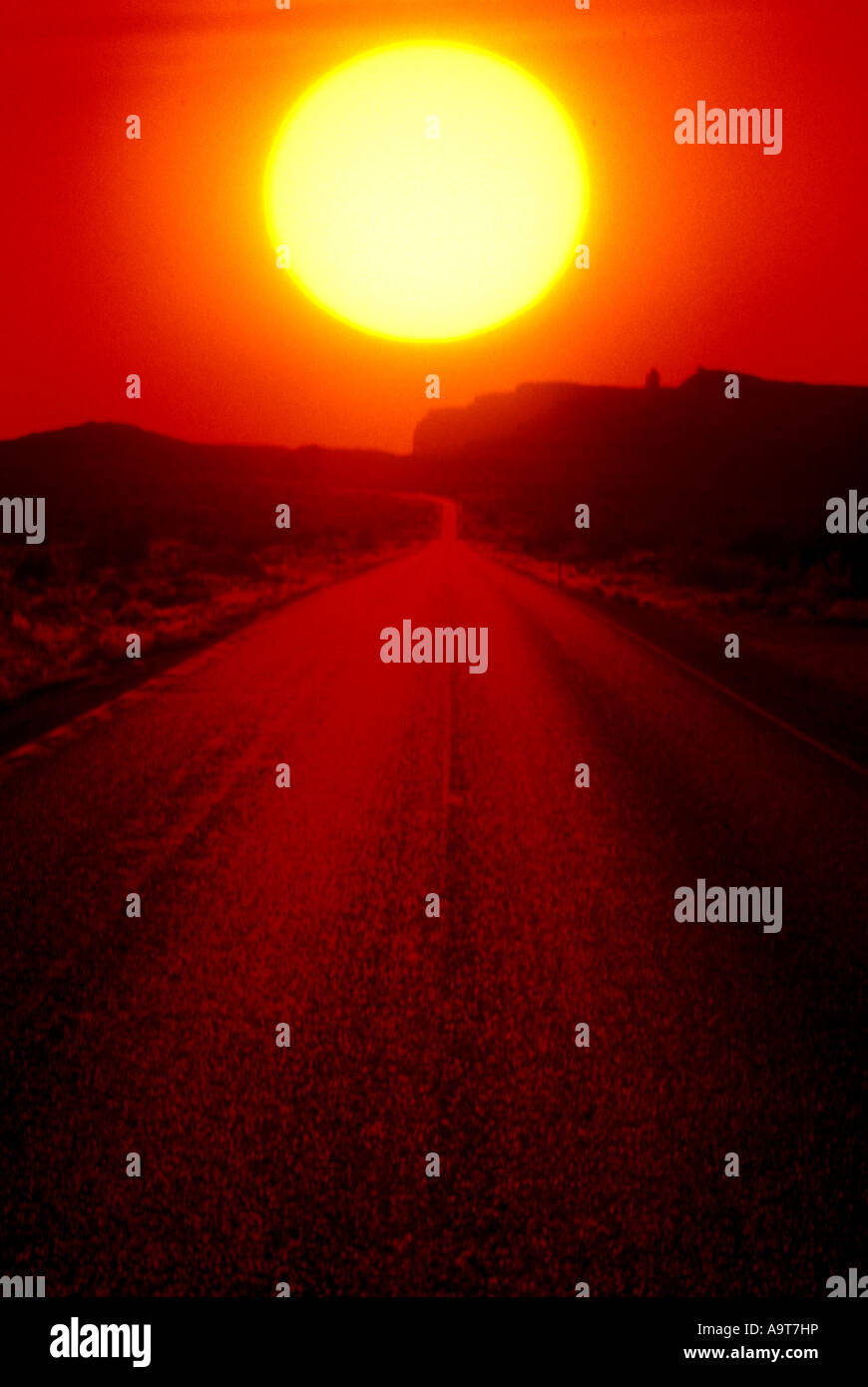 low orange sun over asphalt road Stock Photo - Alamy