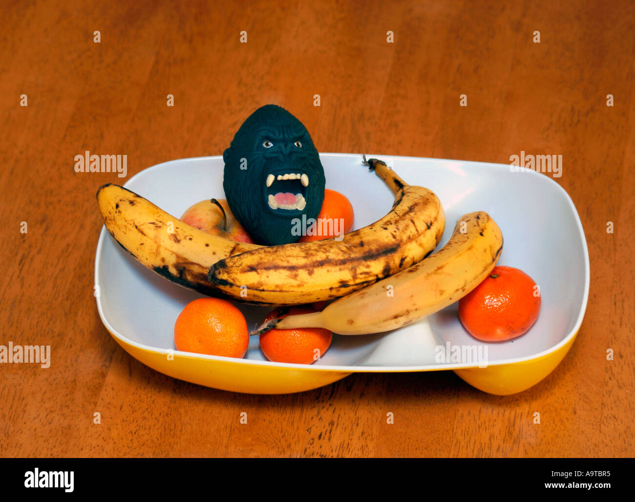 King Kong Toy Head In A Bowel Of Fruit Stock Photo