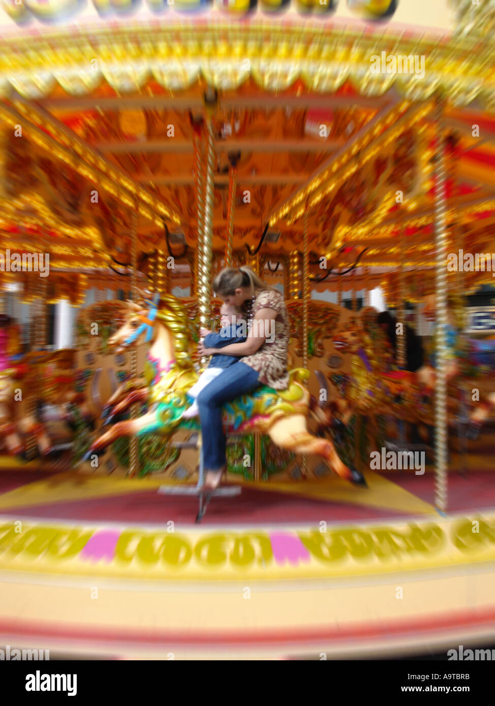 Mother And Child Enjoying Carousel Stock Photo Alamy