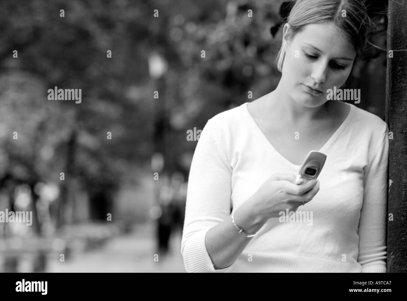 teenager using mobile phone talk text chat handset phone coms communicate