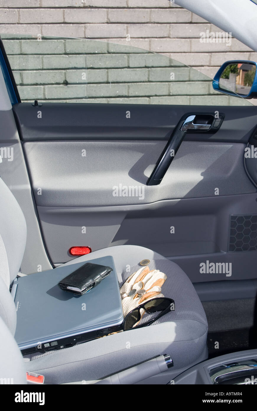 Valuables left on display on car seat with window inadvertently left