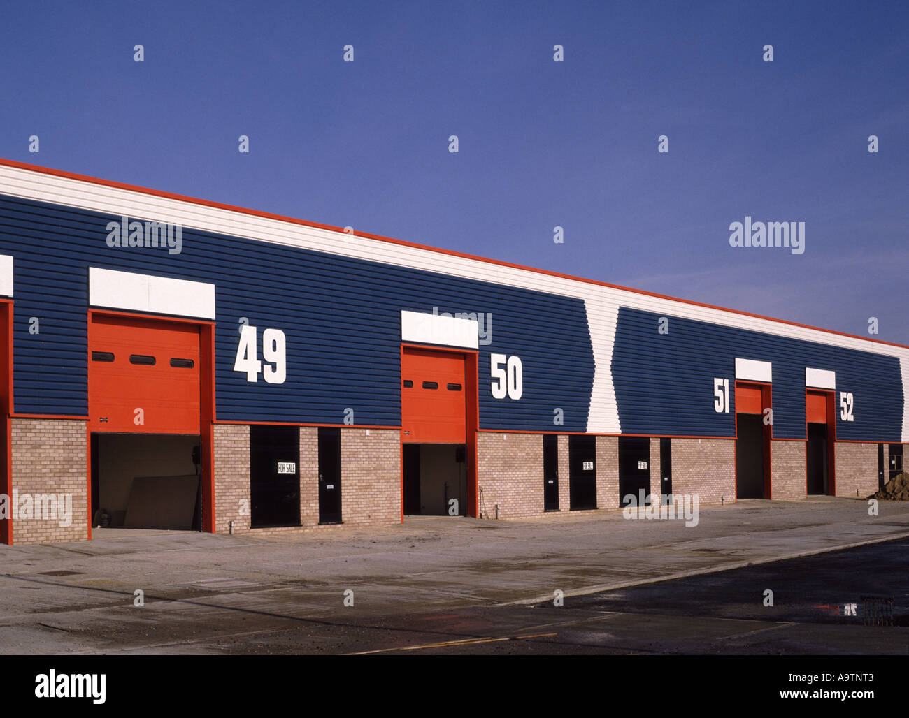 Small light industrial business units in bold colours Stock Photo Alamy