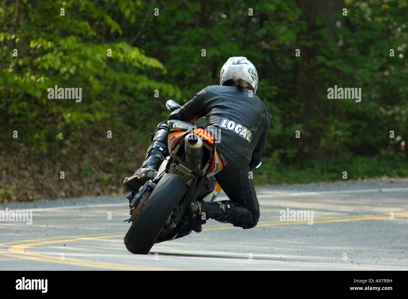 motorcycle taking a curve on a rural road Stock Photo Alamy