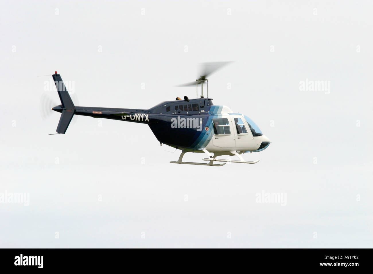 Bell Ranger 206 Bell Jet Ranger 206B civilian helicopter in flight against white sky ...