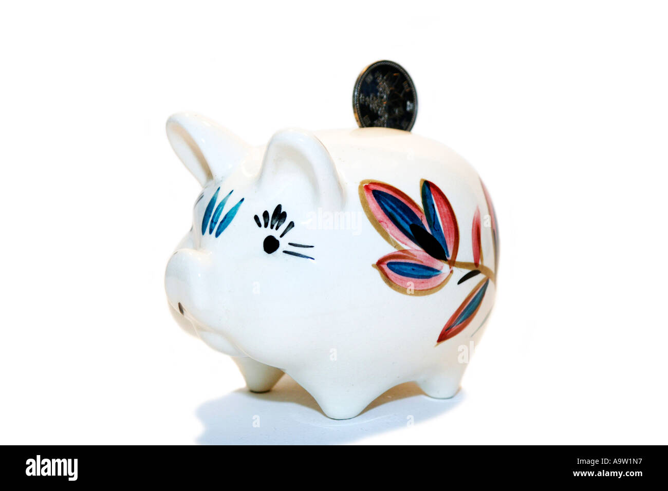 White Piggy Bank pig with a coin being dropped into the slot Stock
