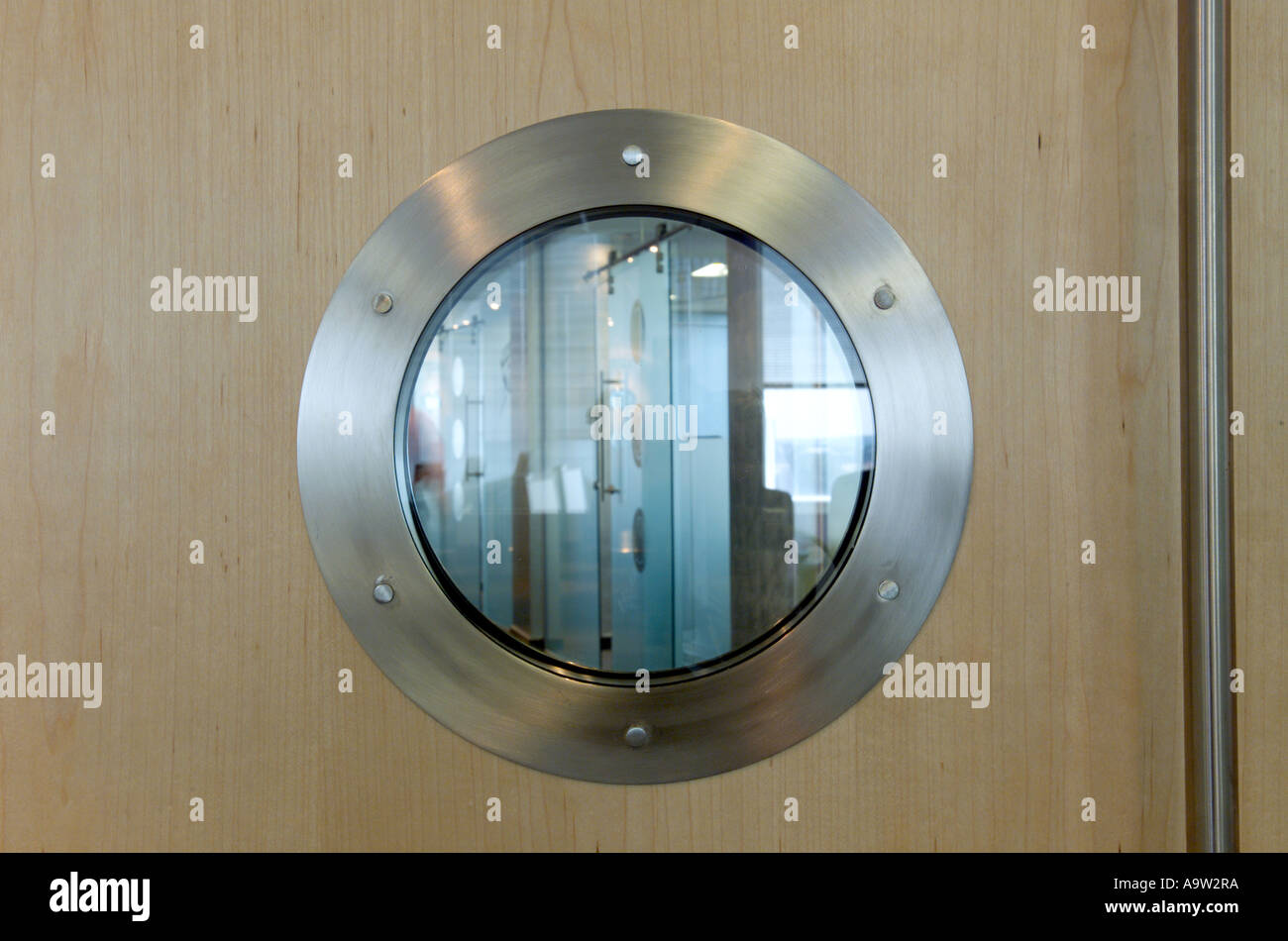 Porthole window in office door Stock Photo