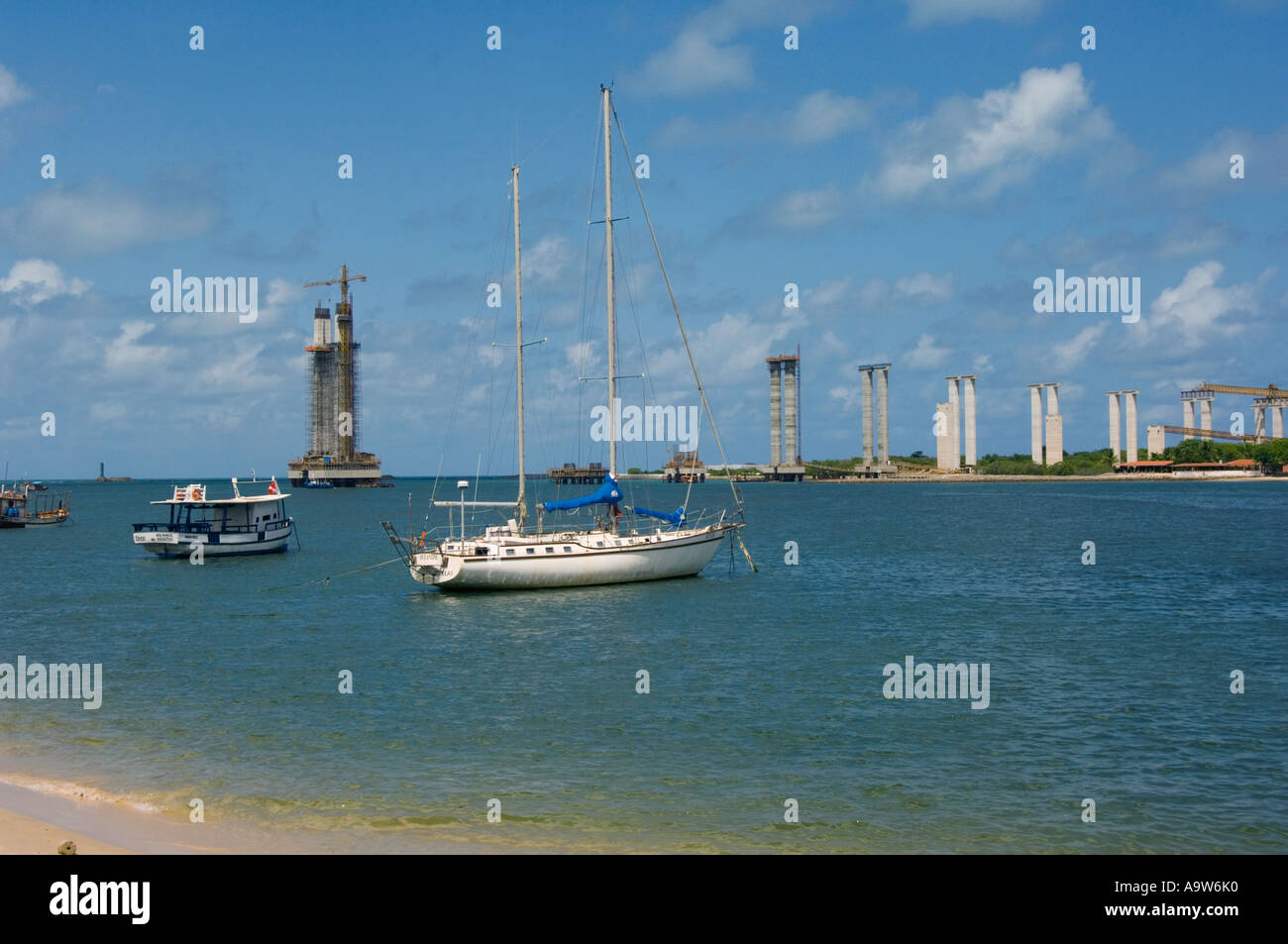 Sailing boat in front of the bridge under construction over the Rio Potengy near Natal Brazil Stock Photo
