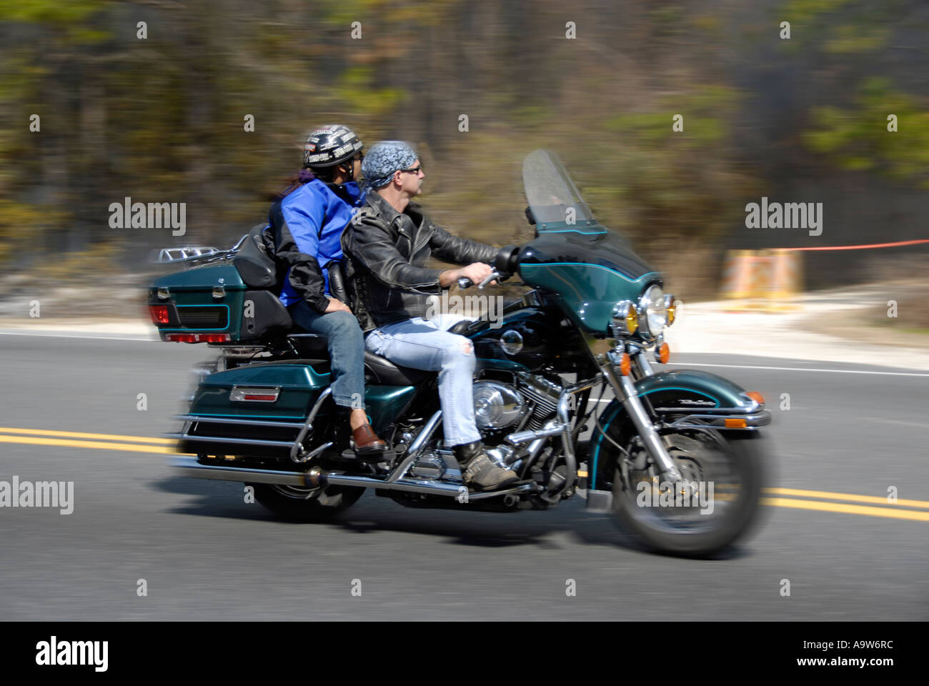 Husband and wife ride motorcycle not wearing protective helmets for  pleasure and recreation Stock Photo - Alamy