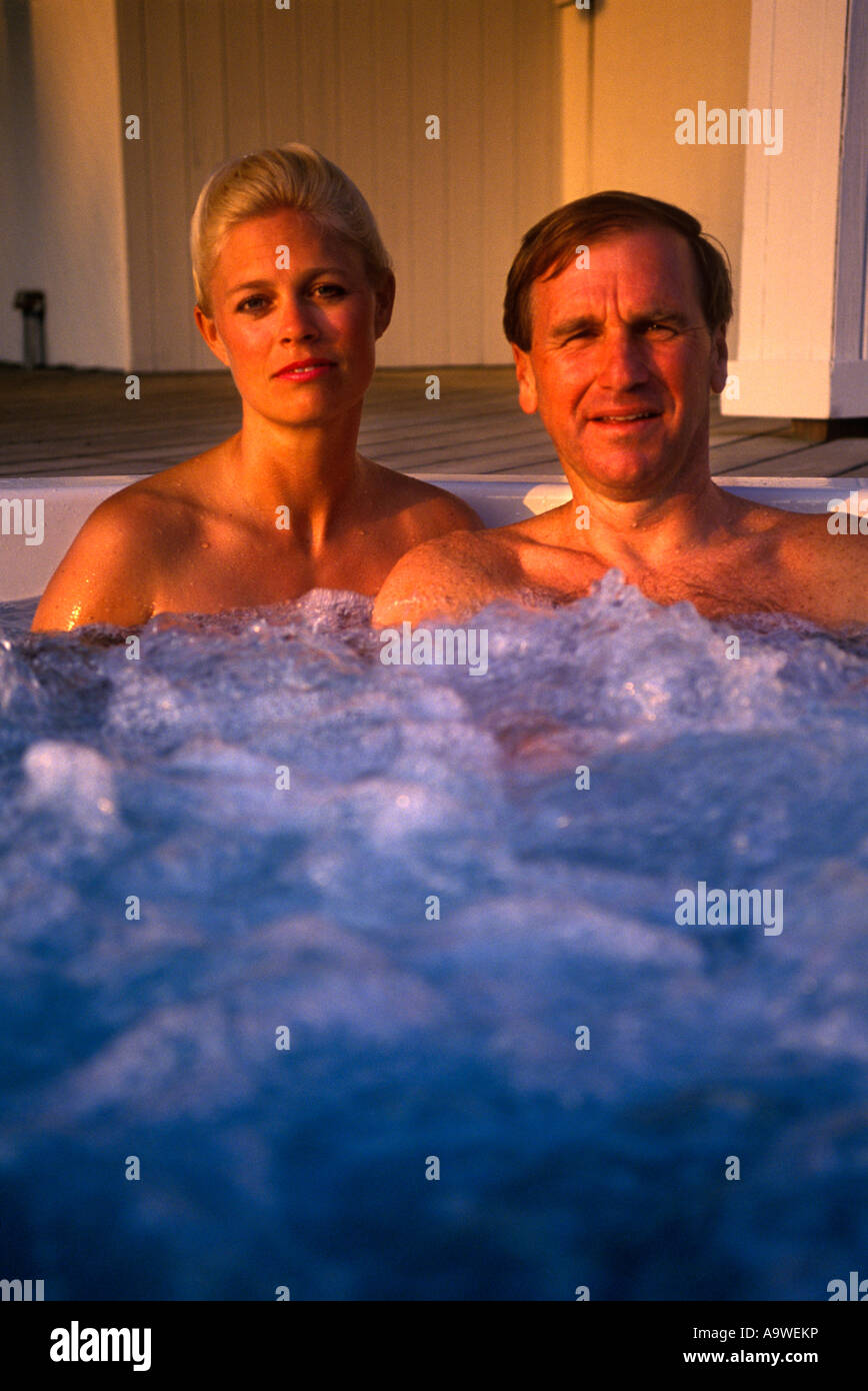 COUPLE RELAXING TOGETHER IN WHIRLPOOL Stock Photo