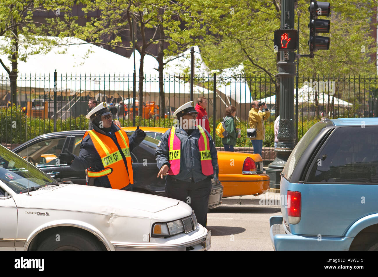 WORKERS Chicago Illinois Two Chicago policewomen stand amid traffic on State Street orange safety vests Stock Photo