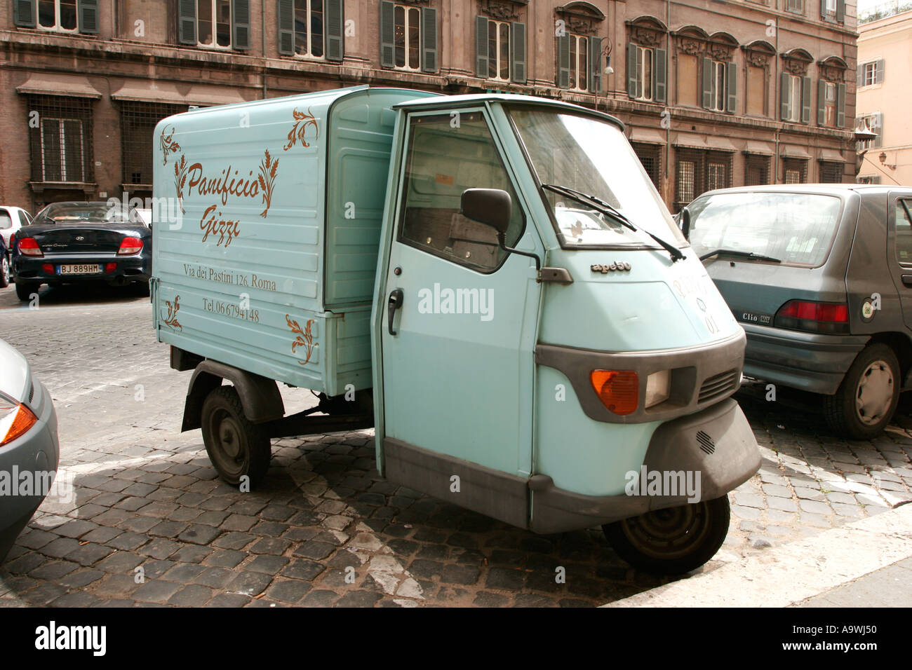 Three wheeled mini van in Rome Italy Stock Photo - Alamy