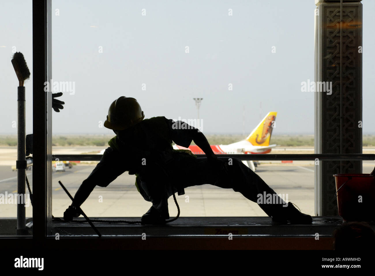 Window cleaner Seeb International airport Muscat Oman Stock Photo